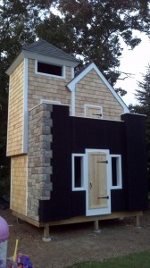 Playhouse design work-in-progress Castle playhouse design mid-project, using drainage mats underneath decorative stone panels to keep out moisture.