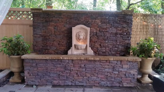 Backyard water wall covered in Regency Stacked Stone panels.