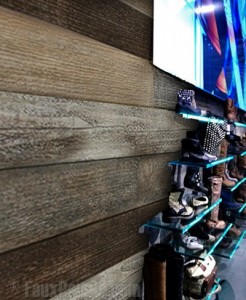 Close up view of faux reclaimed wood panels installed in a retail clothing store.
