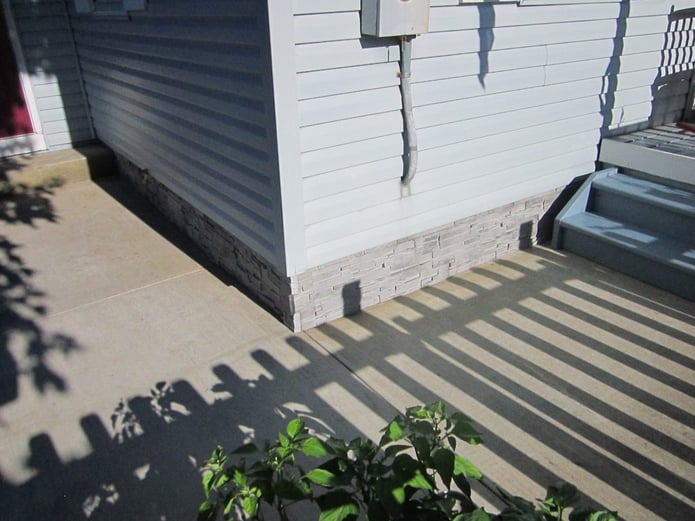 AFTER: Because the veneer siding is tapconned into the wall, there's nothing that can stop it adhering tightly.