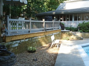 A poolside retaining wall peeling paint and in desperate need of a makeover.