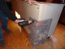 Fasten panels to your kitchen island using screws around the panel’s perimeter. 