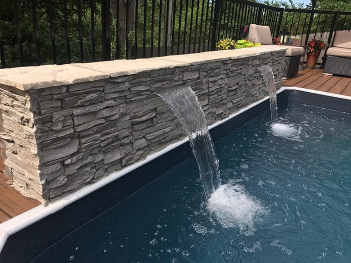 DIY pool waterfall covered in Norwich Stacked stone panels.