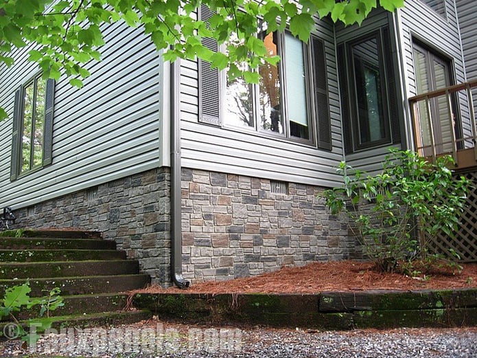 Exterior wainscoting with man made stone paneling.