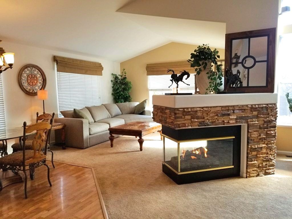 Fantastically retro 3-sided fireplace with stacked stone texture.