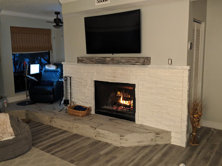 Fireplace updated with a faux white stone surround.
